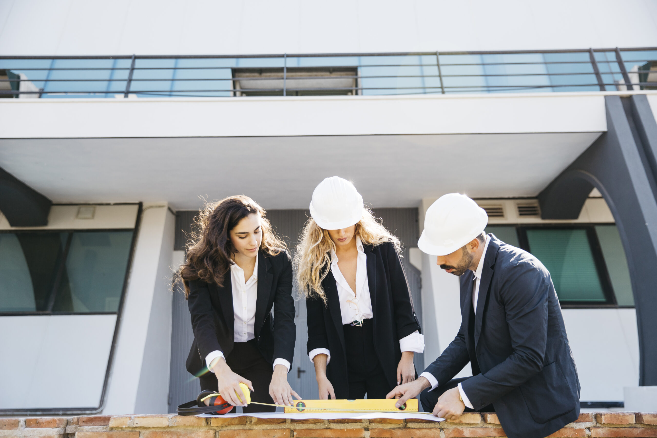 architects-wearing-helmets-looking-plan architects-wearing-helmets-looking-plan